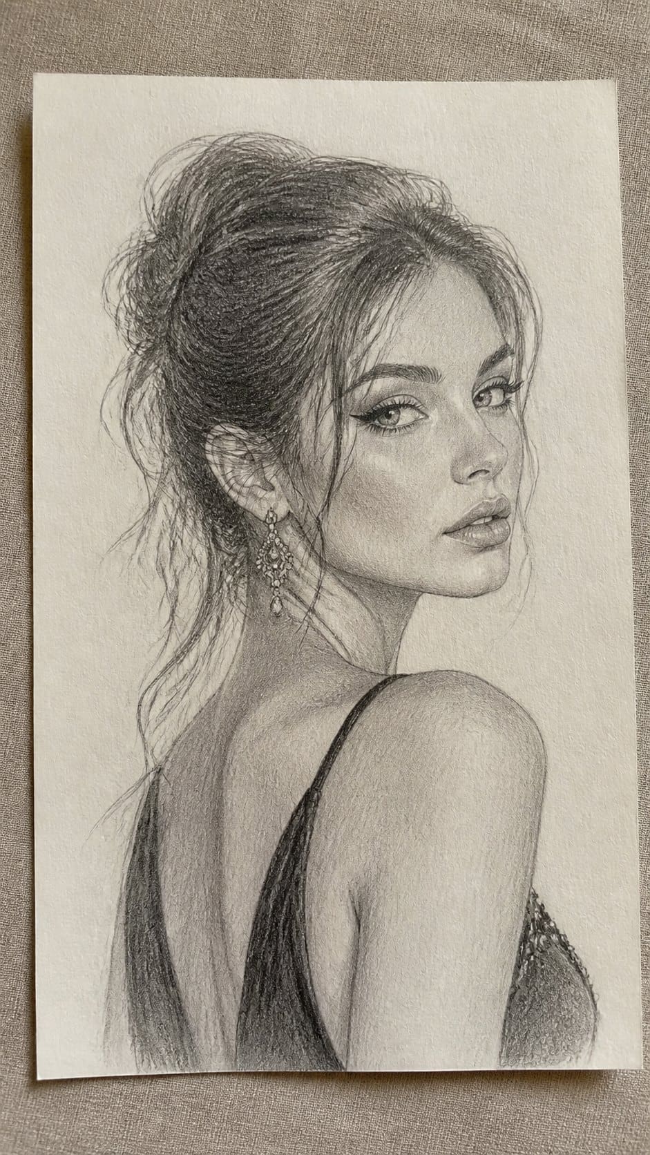 Hand-drawn glamorous gaze in graphite drawing on textured paper, shown in a slightly off-center overhead composition, like an artist — study 1