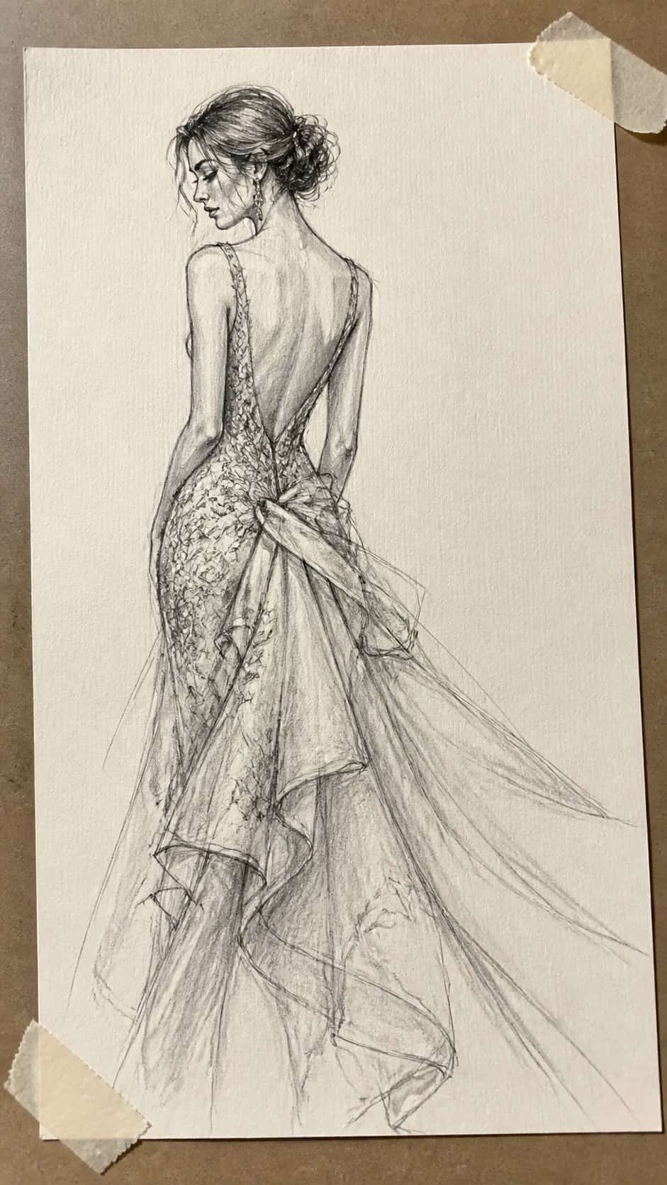 Hand-drawn couture charm in graphite drawing on textured paper, shown in a slightly off-center overhead composition, like an artist — study 1