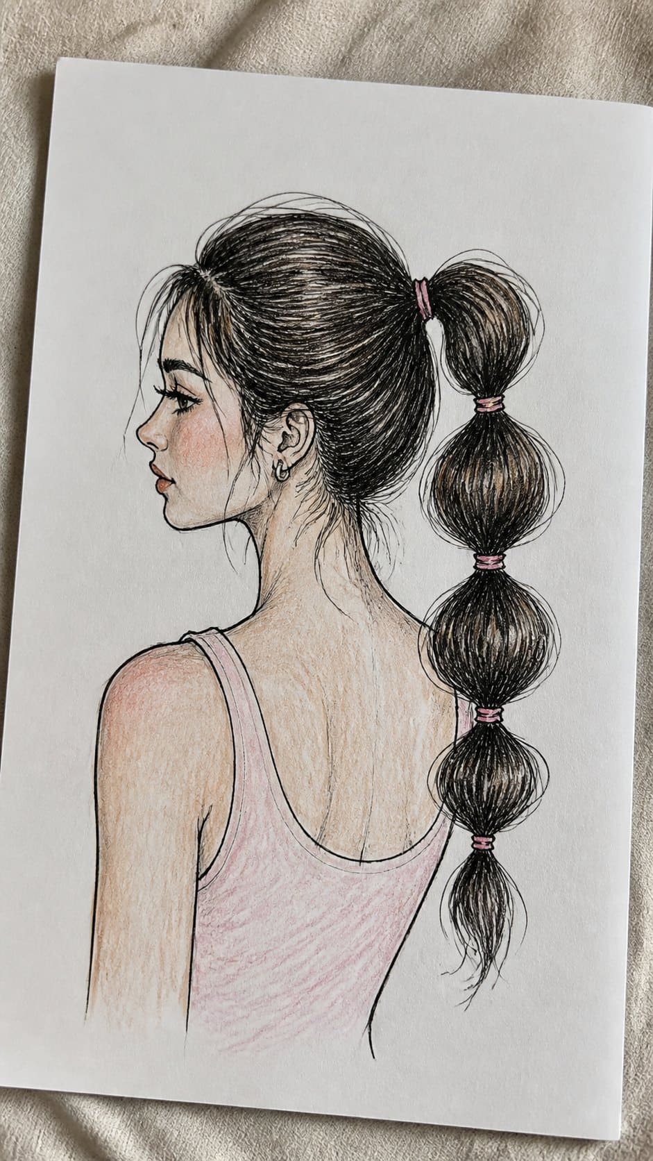 Hand-drawn bubble ponytail in ink and colored-pencil drawing on textured paper, shown in a gentle oblique desk view that shows paper — study 1