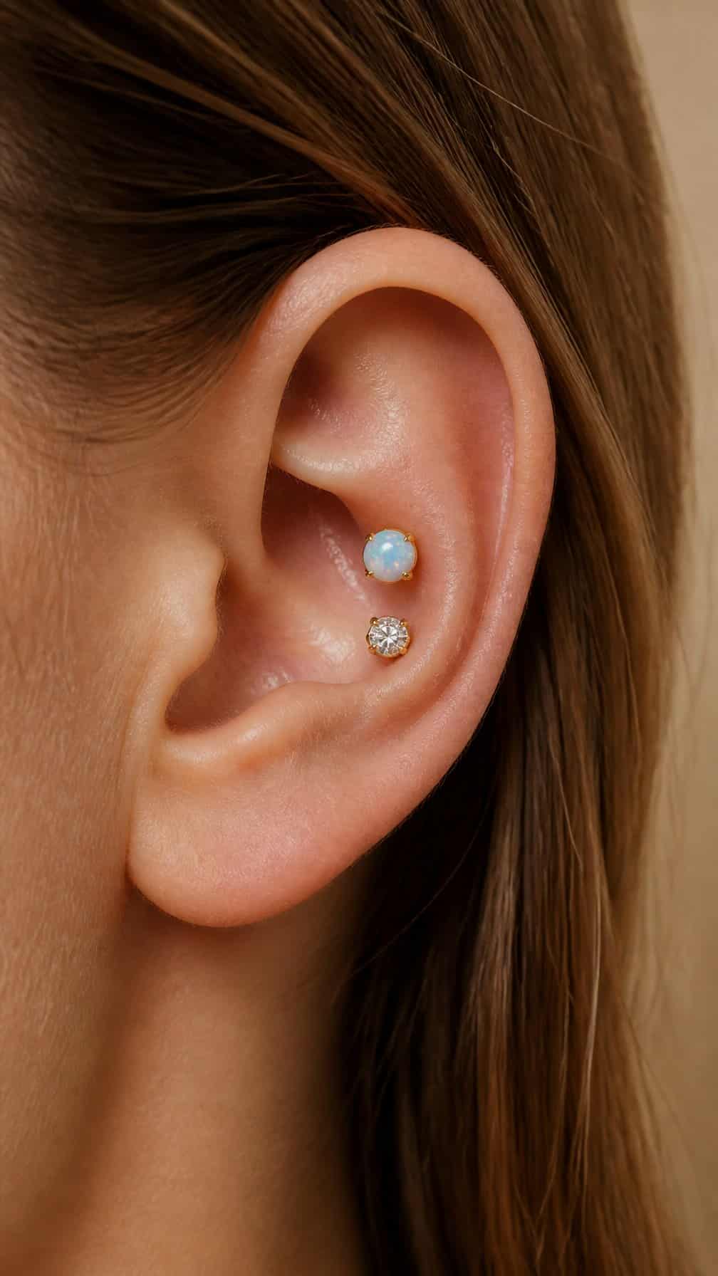 An ear with a glowing opal stud and a small diamond conch piercing.