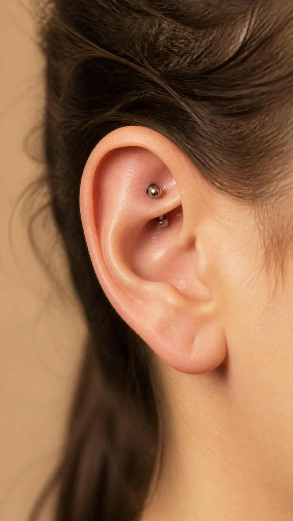 Close-up of an ear with a curved barbell rook piercing in the upper inner cartilage.