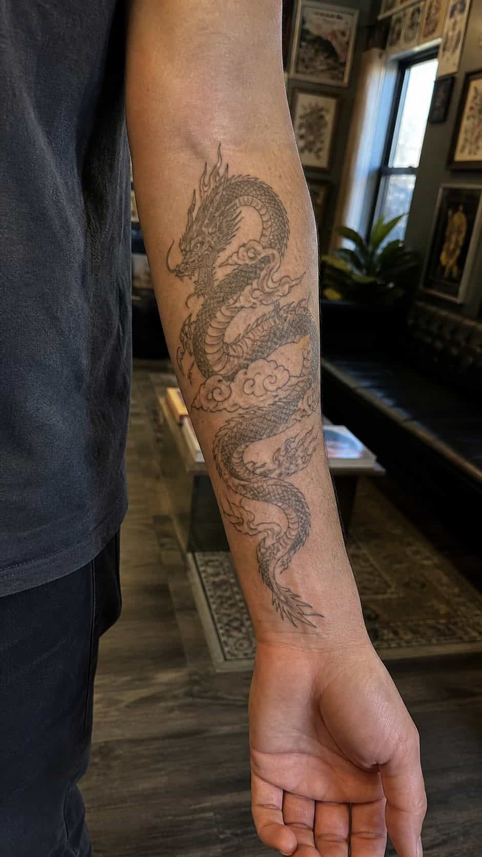 From Samurai to Dragons: 19 Stunning Japanese Tattoo Ideas for Men 9 Healed dragon tattoo on a adult man's inner forearm, photographed in a natural waist-height candid close-up — study 3