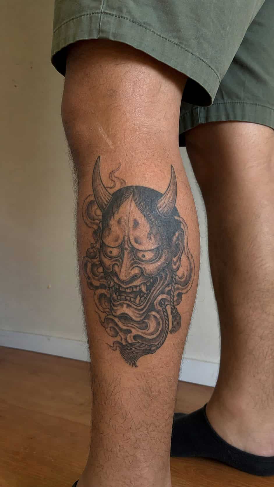 From Samurai to Dragons: 19 Stunning Japanese Tattoo Ideas for Men 18 Healed hannya mask tattoo on a adult man's outer calf, photographed in a natural straight-on close view, a touch off-center like a — study 3