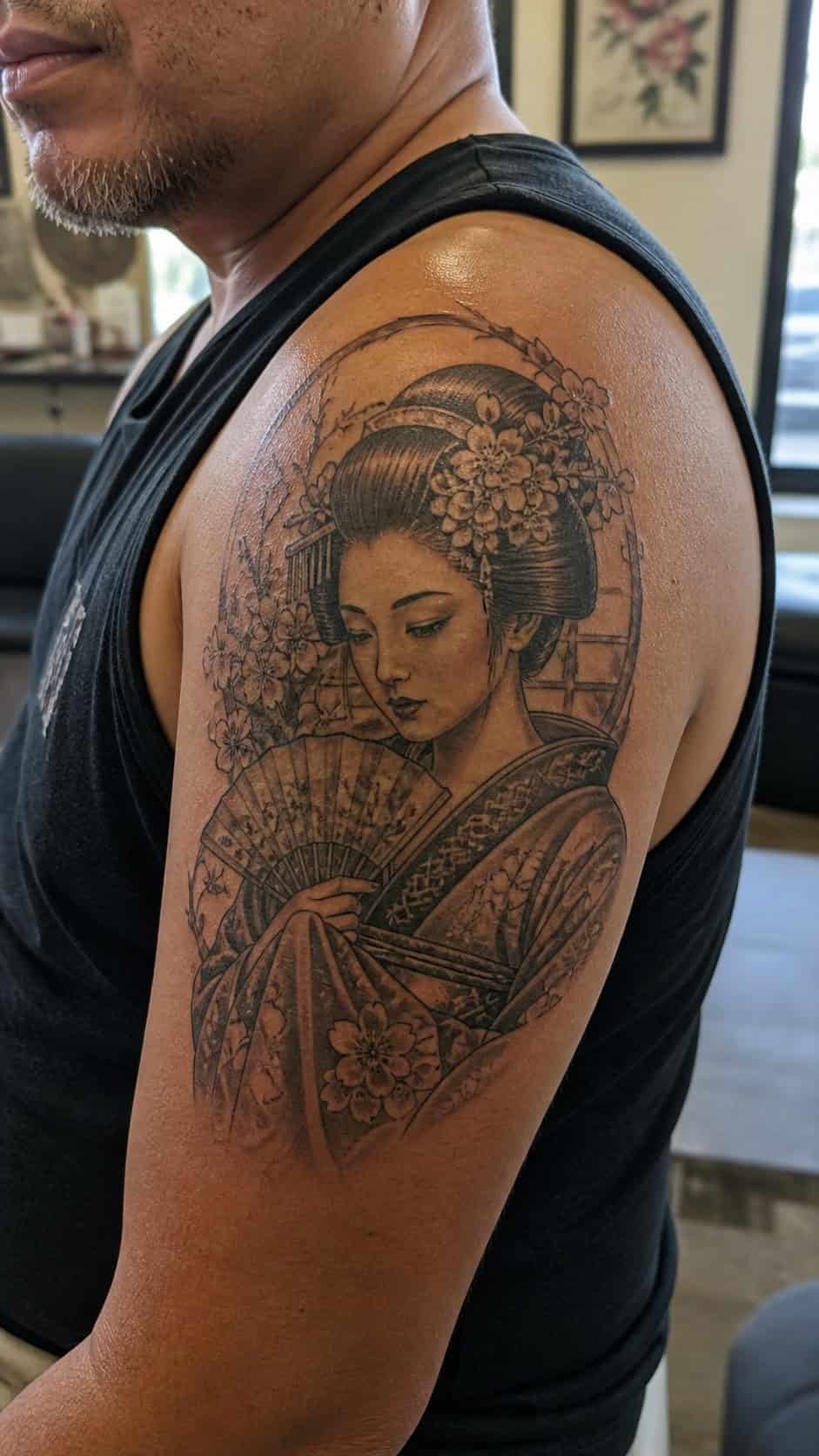 From Samurai to Dragons: 19 Stunning Japanese Tattoo Ideas for Men 23 Healed geisha tattoo on a adult man's shoulder, photographed in a natural straight-on close view, a touch off-center like a quick — study 1