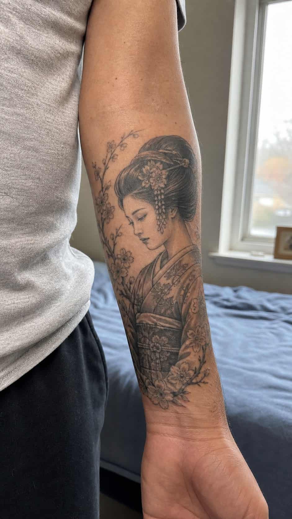 From Samurai to Dragons: 19 Stunning Japanese Tattoo Ideas for Men 24 Healed geisha tattoo on a adult man's inner forearm, photographed in a natural gentle side angle that clearly shows how the ink wraps — study 2