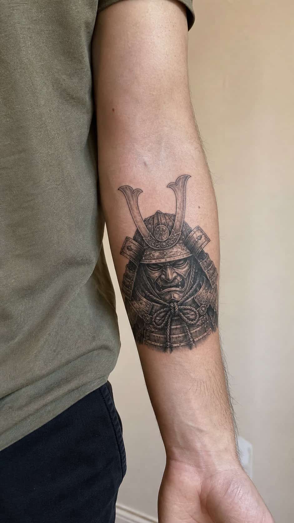 From Samurai to Dragons: 19 Stunning Japanese Tattoo Ideas for Men 27 Healed samurai helmet (kabuto) tattoo on a adult man's inner forearm, photographed in a natural gentle side angle that clearly shows — study 1