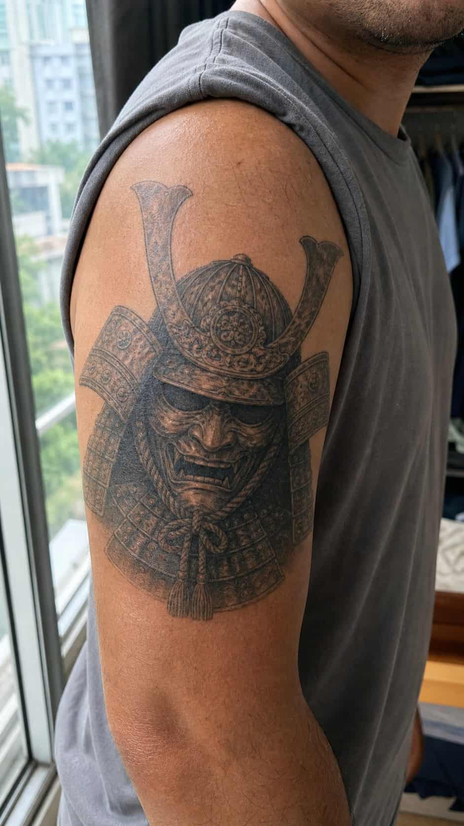From Samurai to Dragons: 19 Stunning Japanese Tattoo Ideas for Men 28 Healed samurai helmet (kabuto) tattoo on a adult man's outer upper arm, photographed in a natural slightly elevated close view — study 2