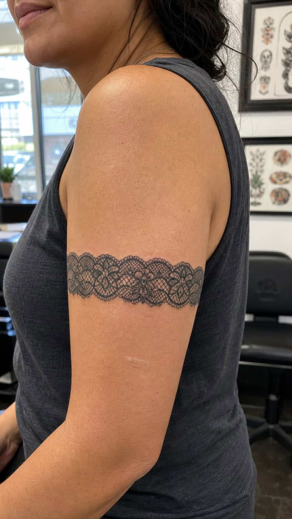 Healed intricate lace band tattoo on a adult woman's outer upper arm, photographed in a natural gentle side angle that clearly shows — study 1