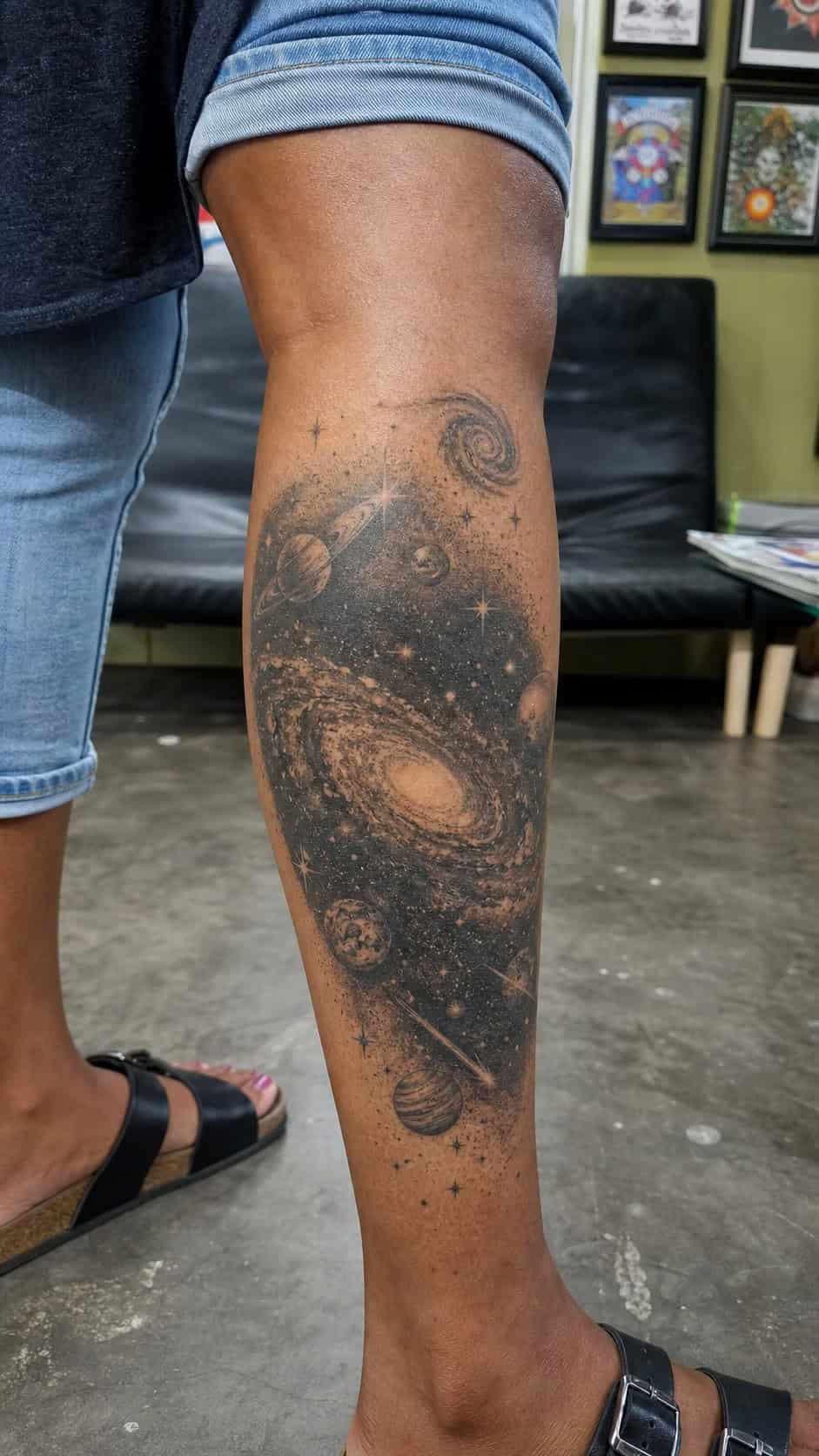 Healed cosmic galaxy scene tattoo on a adult woman's outer calf, photographed in a natural straight-on close view, a touch off-center — study 1