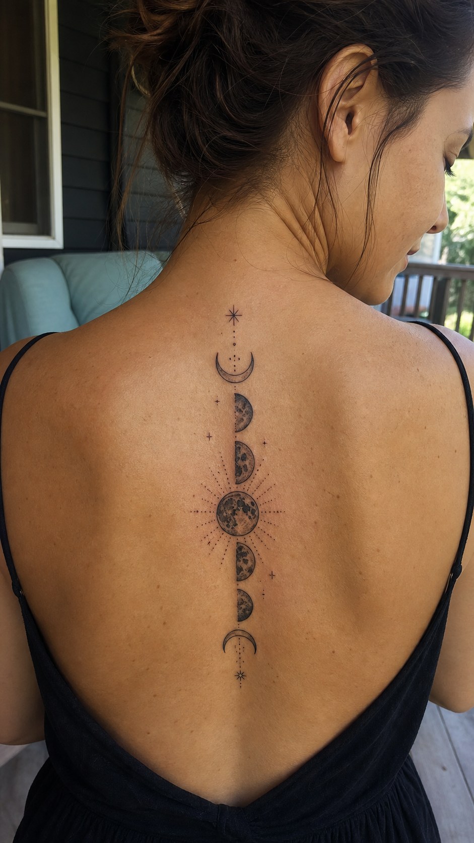 Healed mystical moon phases tattoo on a adult woman's upper back, photographed in a natural straight-on close view, a touch off-center — study 1