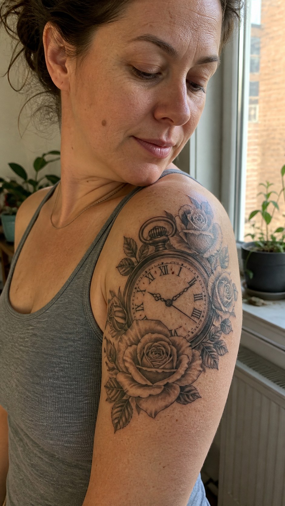 Healed timeless clock and roses tattoo on a adult woman's shoulder, photographed in a natural waist-height candid close-up — study 1