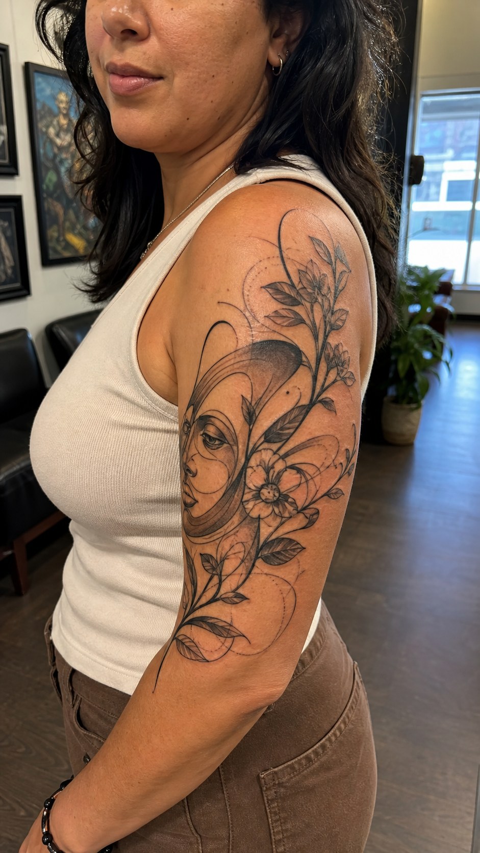 Healed surreal abstract art tattoo on a adult woman's outer upper arm, photographed in a natural gentle side angle that clearly shows — study 1
