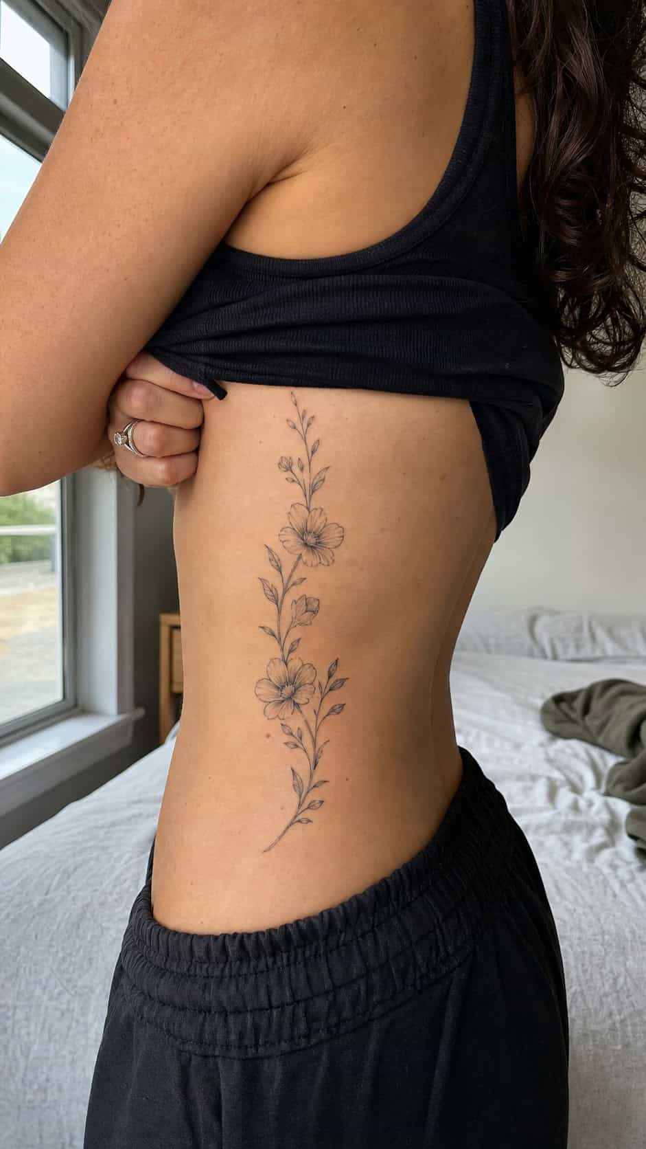32 Stunning Rib Tattoos for Women 2 Healed floral vine elegance tattoo on a adult woman's side ribs, photographed in a natural relaxed documentary crop — study 1