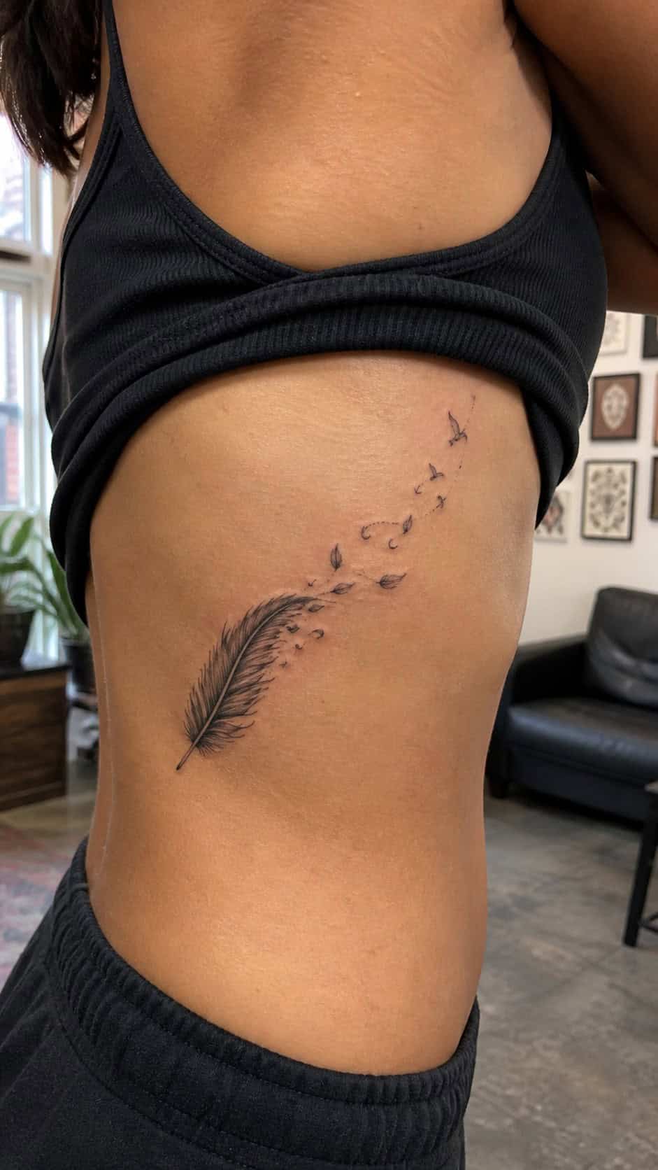 32 Stunning Rib Tattoos for Women 7 Healed feather in the wind tattoo on a adult woman's side ribs, photographed in a natural gentle side angle that clearly shows how the — study 2