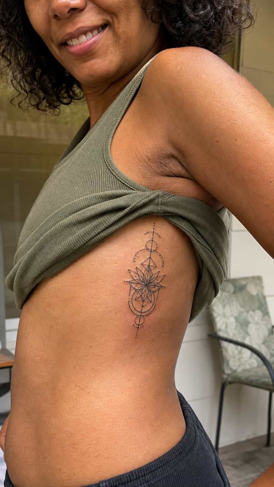 32 Stunning Rib Tattoos for Women 13 Healed geometric patterns tattoo on a adult woman's side ribs, photographed in a natural casual close three-quarter view — study 2