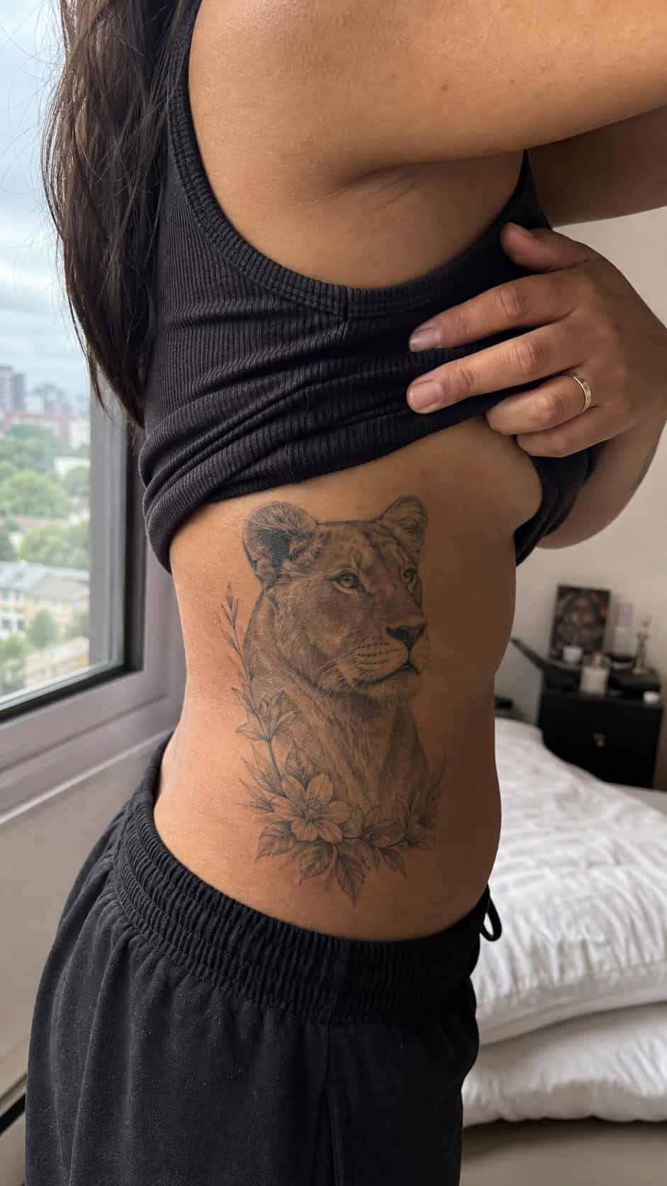 32 Stunning Rib Tattoos for Women 14 Healed animal portrait tattoo on a adult woman's side ribs, photographed in a natural casual close three-quarter view — study 1