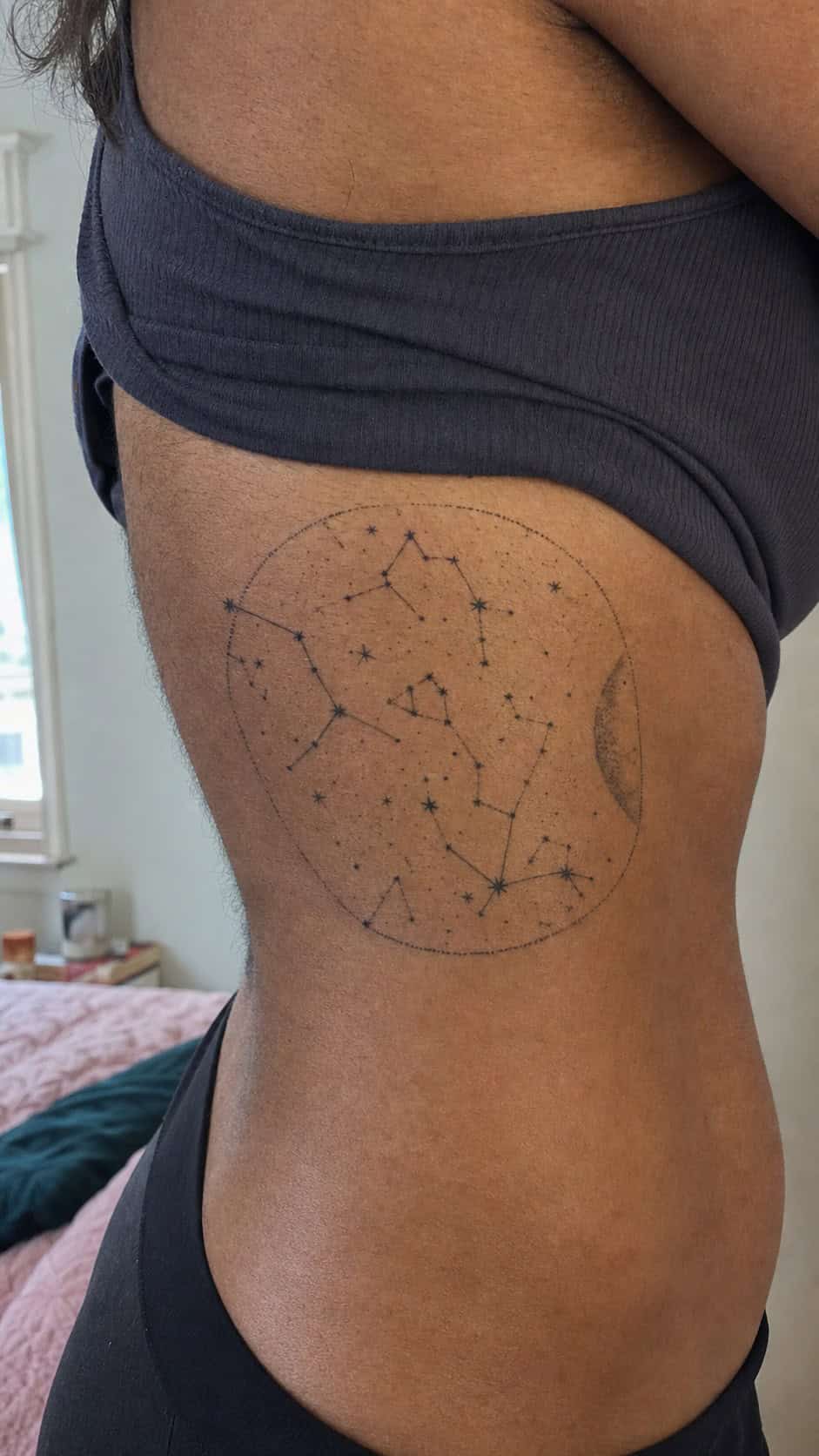 32 Stunning Rib Tattoos for Women 26 Healed constellation map tattoo on a adult woman's side ribs, photographed in a natural relaxed documentary crop — study 1