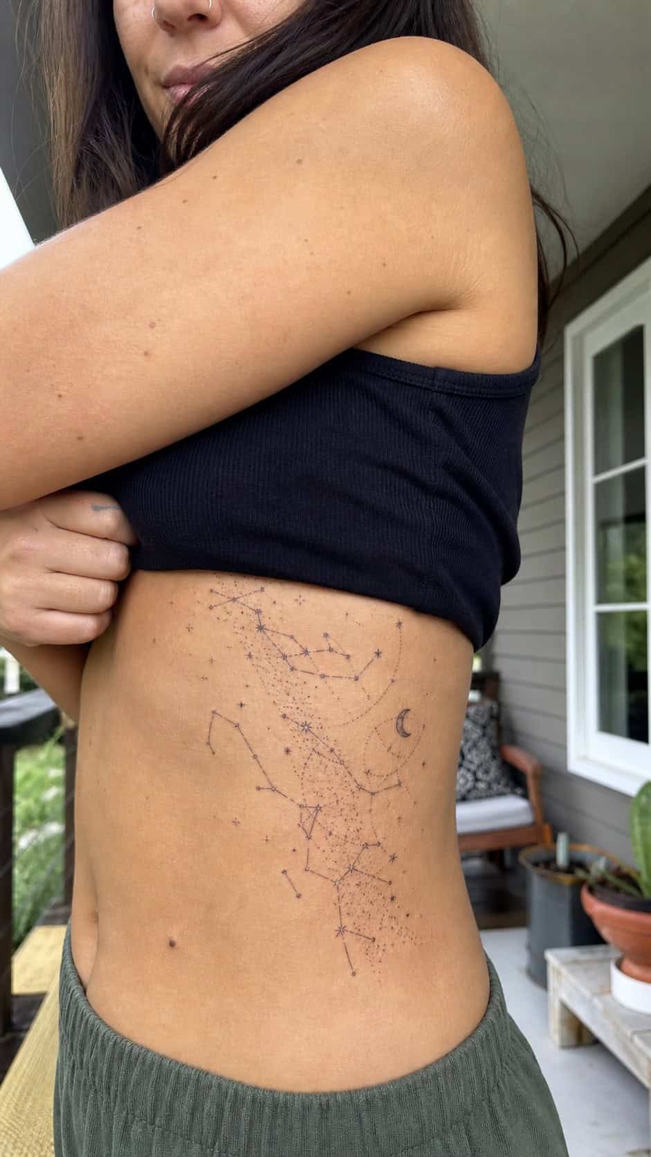 32 Stunning Rib Tattoos for Women 27 Healed constellation map tattoo on a adult woman's side ribs, photographed in a natural casual close three-quarter view — study 2