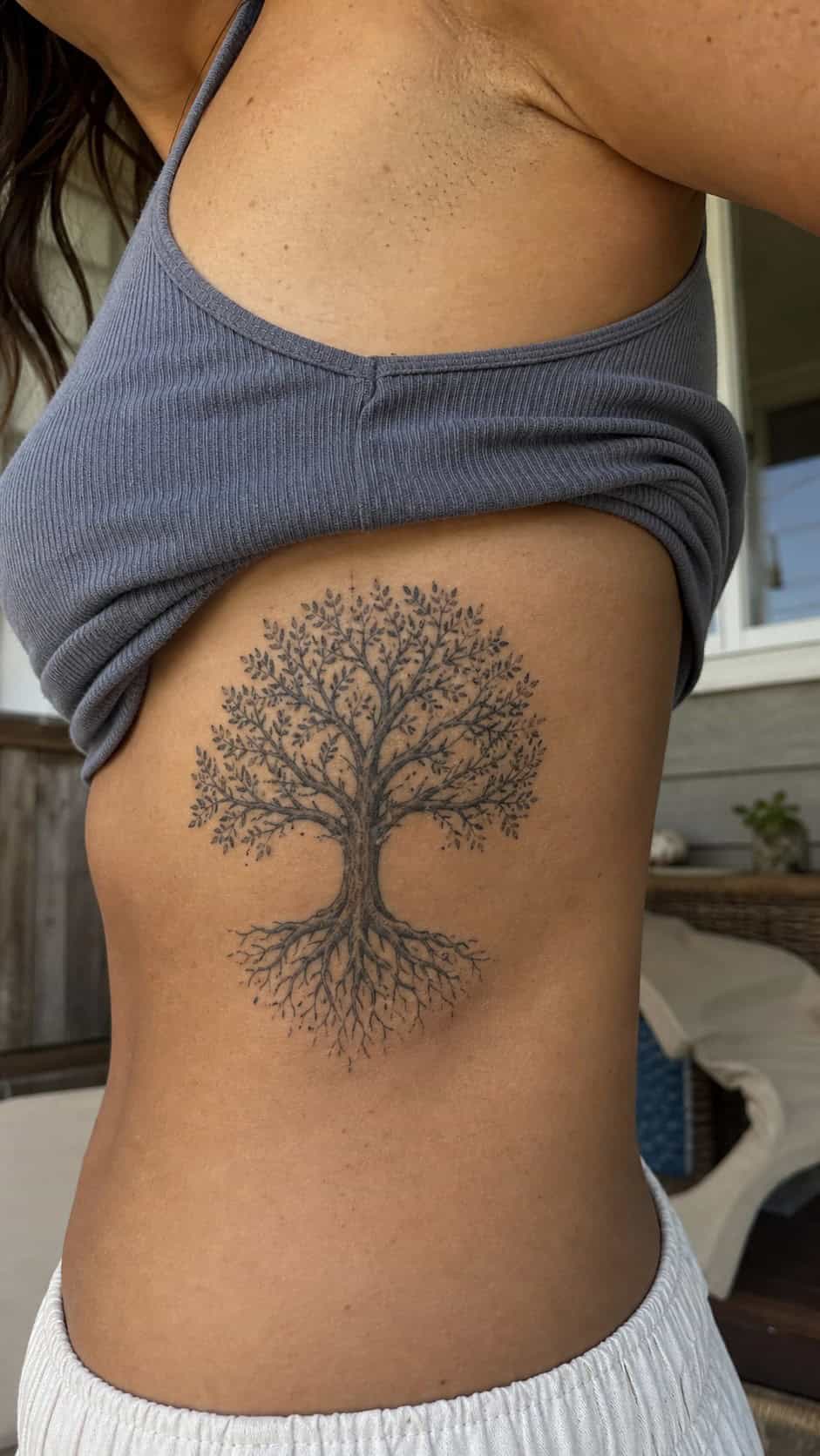 32 Stunning Rib Tattoos for Women 33 Healed tree of life tattoo on a adult woman's side ribs, photographed in a natural slightly elevated close view — study 2