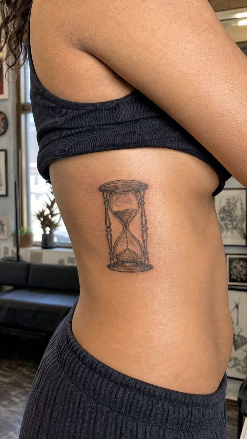 32 Stunning Rib Tattoos for Women 35 Healed hourglass tattoo on a adult woman's side ribs, photographed in a natural slightly elevated close view — study 2