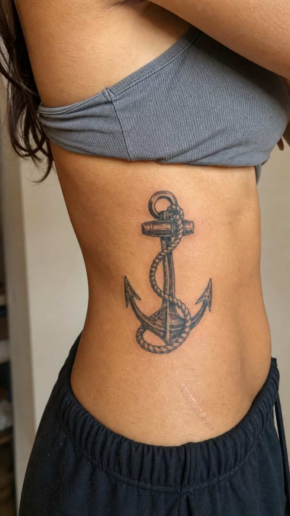 32 Stunning Rib Tattoos for Women 37 Healed anchor and rope tattoo on a adult woman's side ribs, photographed in a natural gentle side angle that clearly shows how the ink — study 1