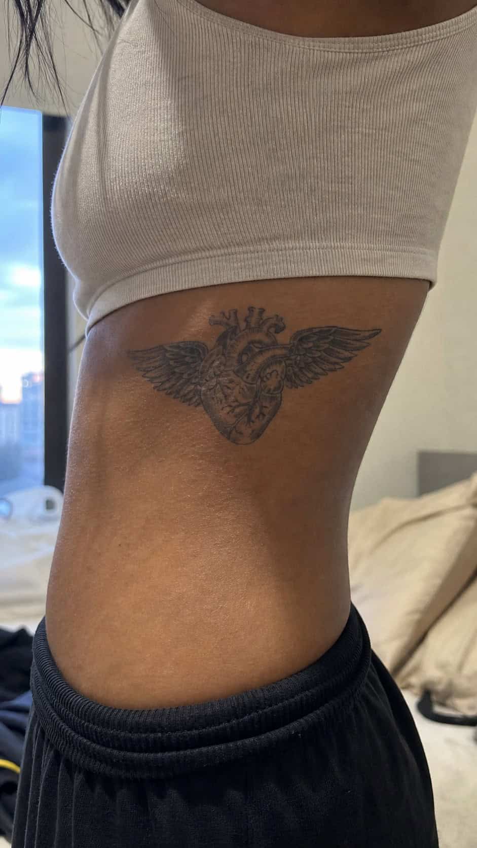32 Stunning Rib Tattoos for Women 40 Healed winged heart tattoo on a adult woman's behind the ear, photographed in a natural gentle side angle that clearly shows how the — study 2