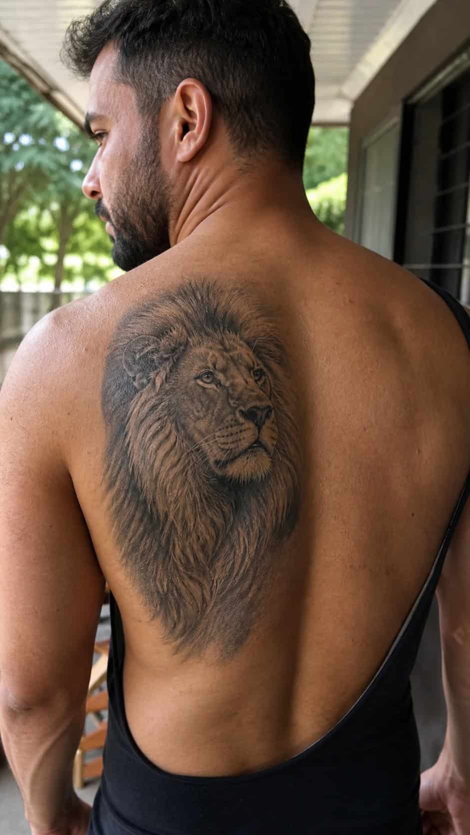 The Art of Ink: 23 Inspirational Back Tattoos for Men 6 Healed realistic lion tattoo on a adult man's upper back, photographed in a natural gentle side angle that clearly shows how the ink — study 2
