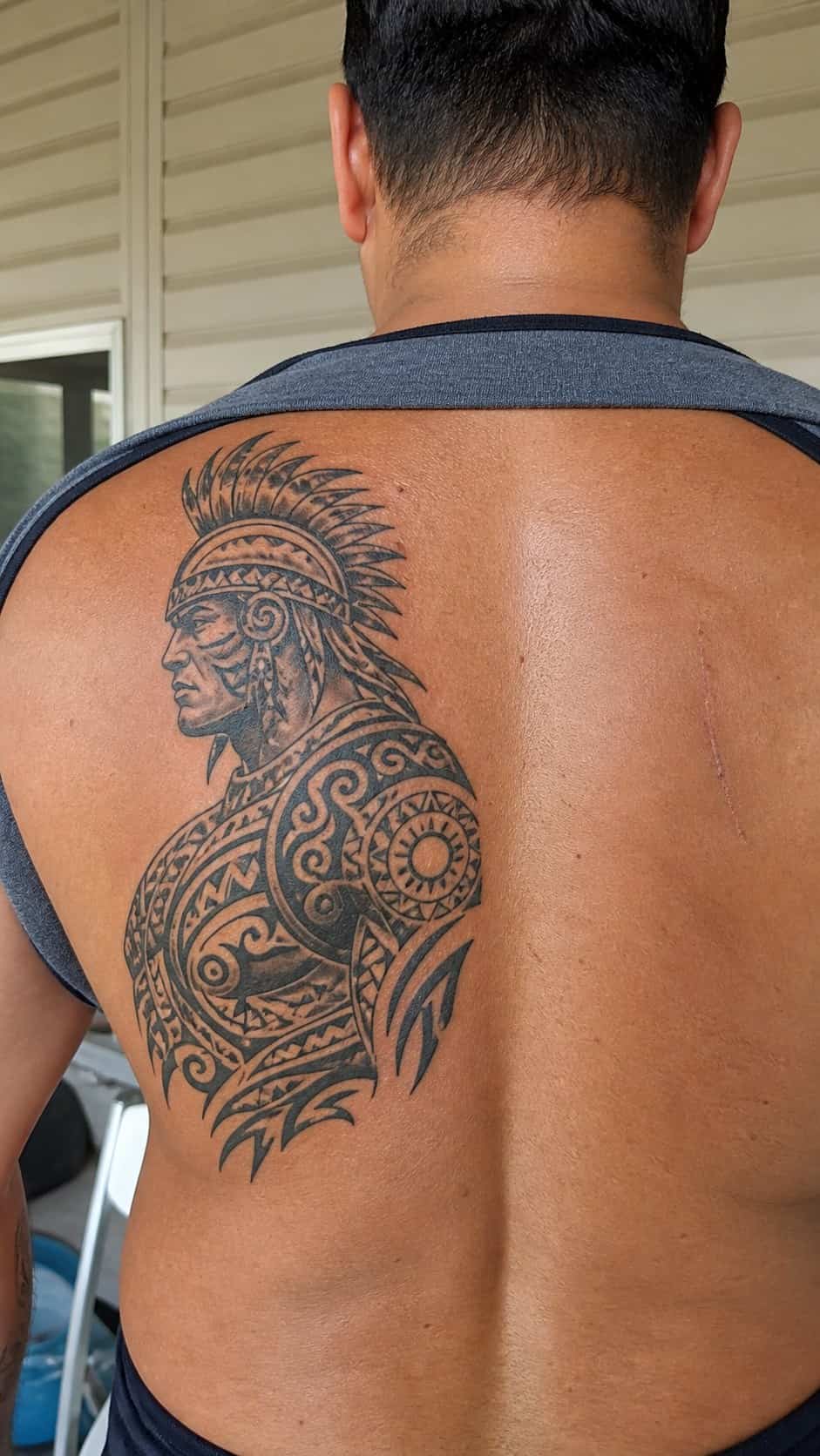 The Art of Ink: 23 Inspirational Back Tattoos for Men 7 Healed tribal warrior tattoo on a adult man's side ribs, photographed in a natural straight-on close view, a touch off-center like a — study 1