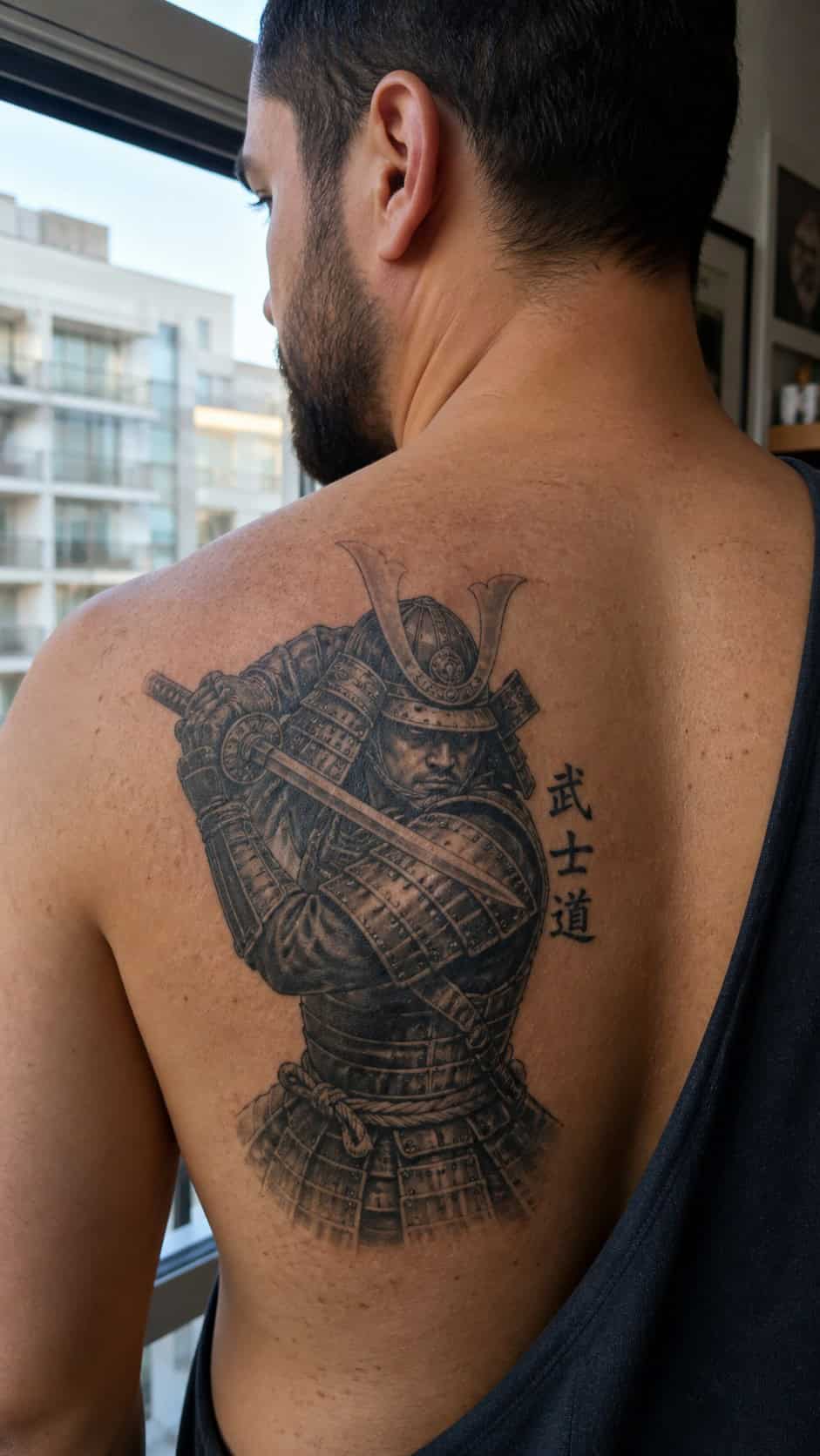 The Art of Ink: 23 Inspirational Back Tattoos for Men 22 Healed samurai warrior tattoo on a adult man's upper back, photographed in a natural waist-height candid close-up — study 1