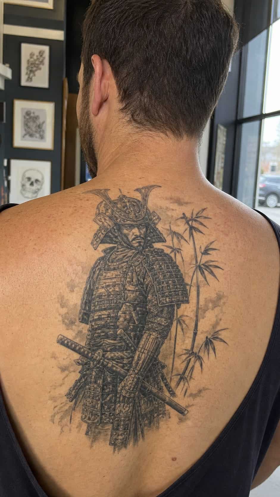 The Art of Ink: 23 Inspirational Back Tattoos for Men 23 Healed samurai warrior tattoo on a adult man's upper back, photographed in a natural relaxed documentary crop — study 2