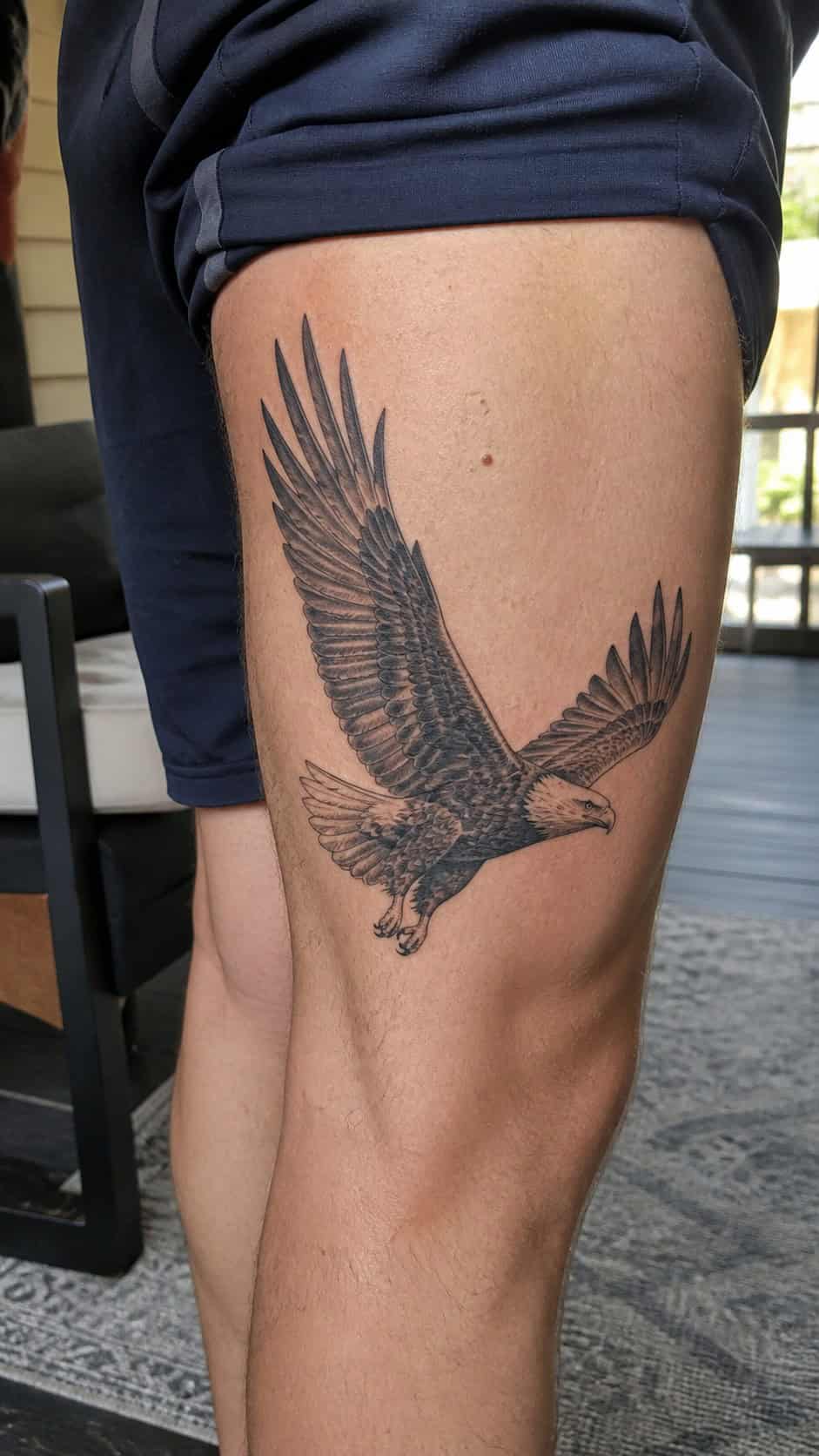 Feeling Bold? Try These 25 Killer Thigh Tattoo Ideas for Men 4 Healed majestic eagle in flight tattoo on a adult man's outer thigh, photographed in a natural gentle side angle that clearly shows — study 1