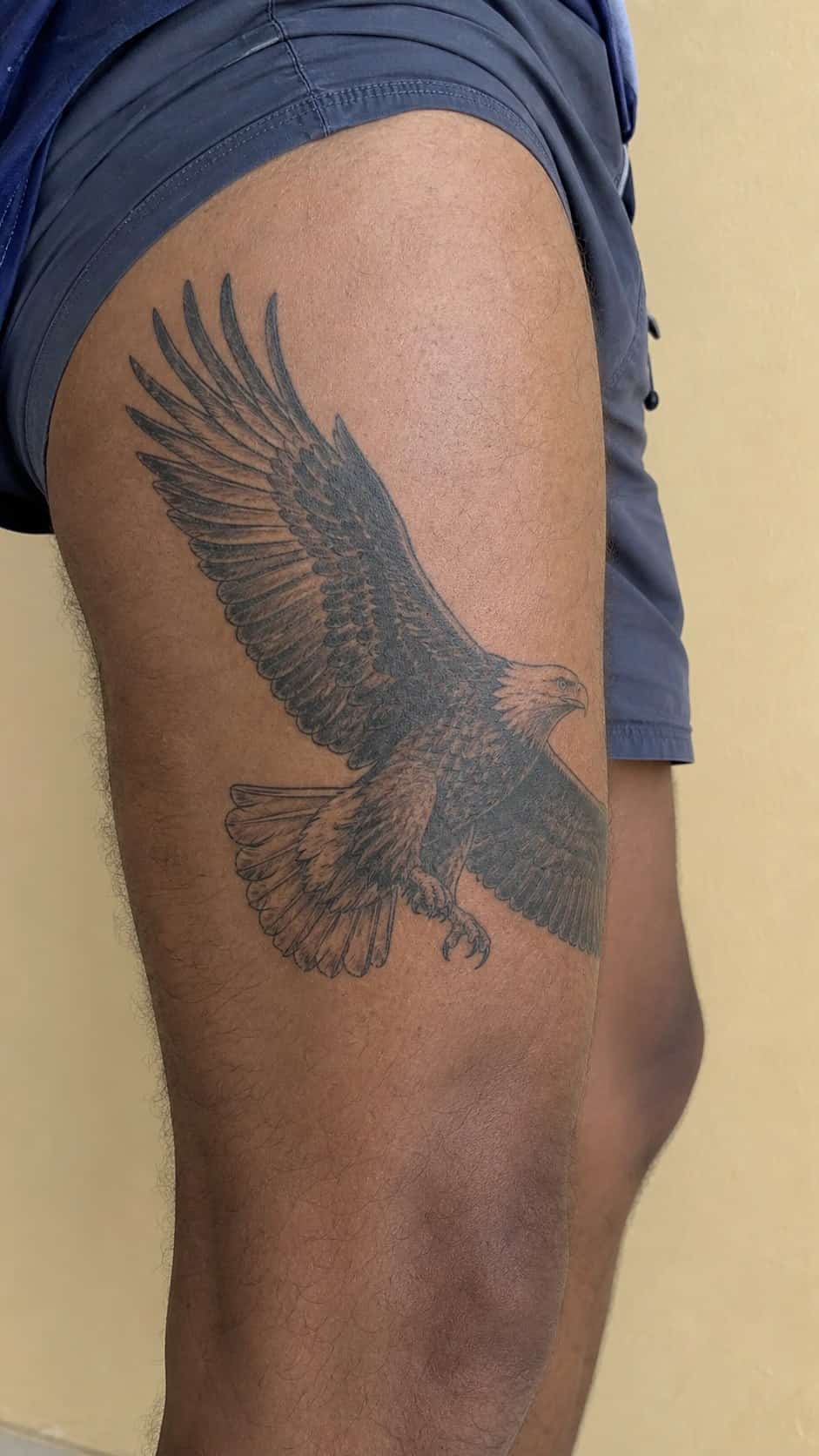 Feeling Bold? Try These 25 Killer Thigh Tattoo Ideas for Men 5 Healed majestic eagle in flight tattoo on a adult man's outer thigh, photographed in a natural slightly elevated close view — study 2