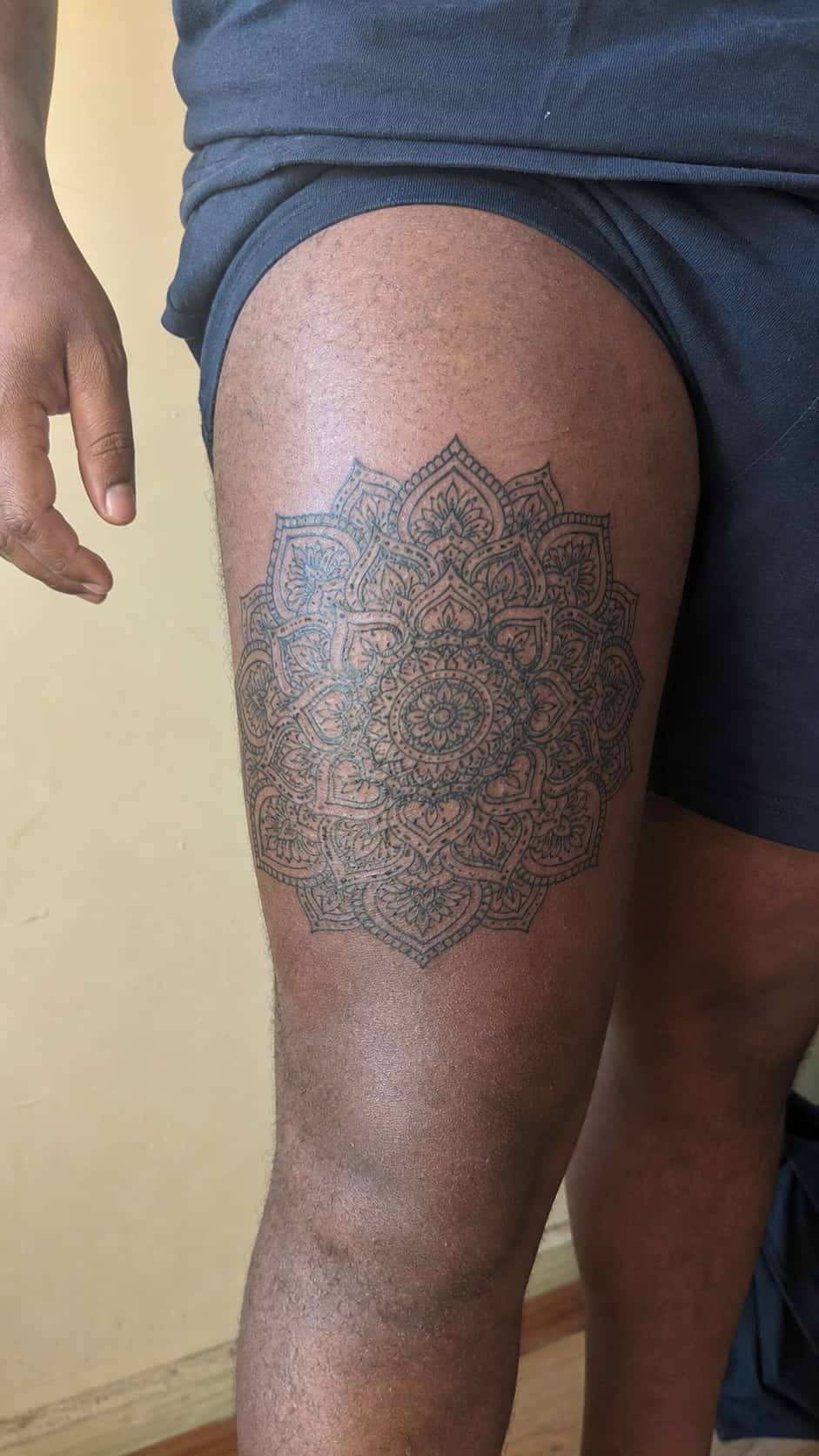 Feeling Bold? Try These 25 Killer Thigh Tattoo Ideas for Men 9 Healed intricate mandala pattern tattoo on a adult man's outer thigh, photographed in a natural straight-on close view, a touch — study 1