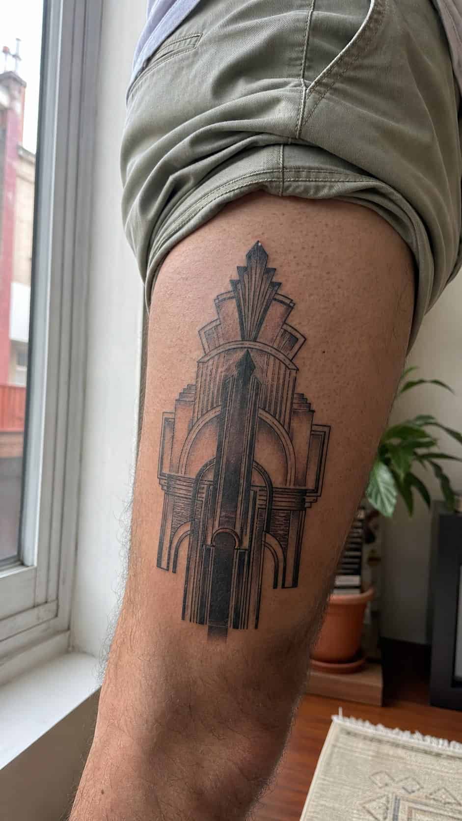 Feeling Bold? Try These 25 Killer Thigh Tattoo Ideas for Men 32 Healed modern art deco tattoo on a adult man's outer thigh, photographed in a natural relaxed documentary crop — study 2