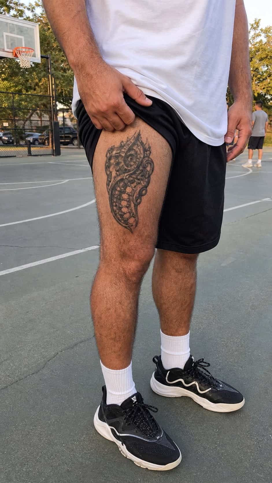 Feeling Bold? Try These 25 Killer Thigh Tattoo Ideas for Men 45 Healed biomechanical fusion tattoo on a adult man's outer thigh, photographed in a natural relaxed documentary crop — study 2