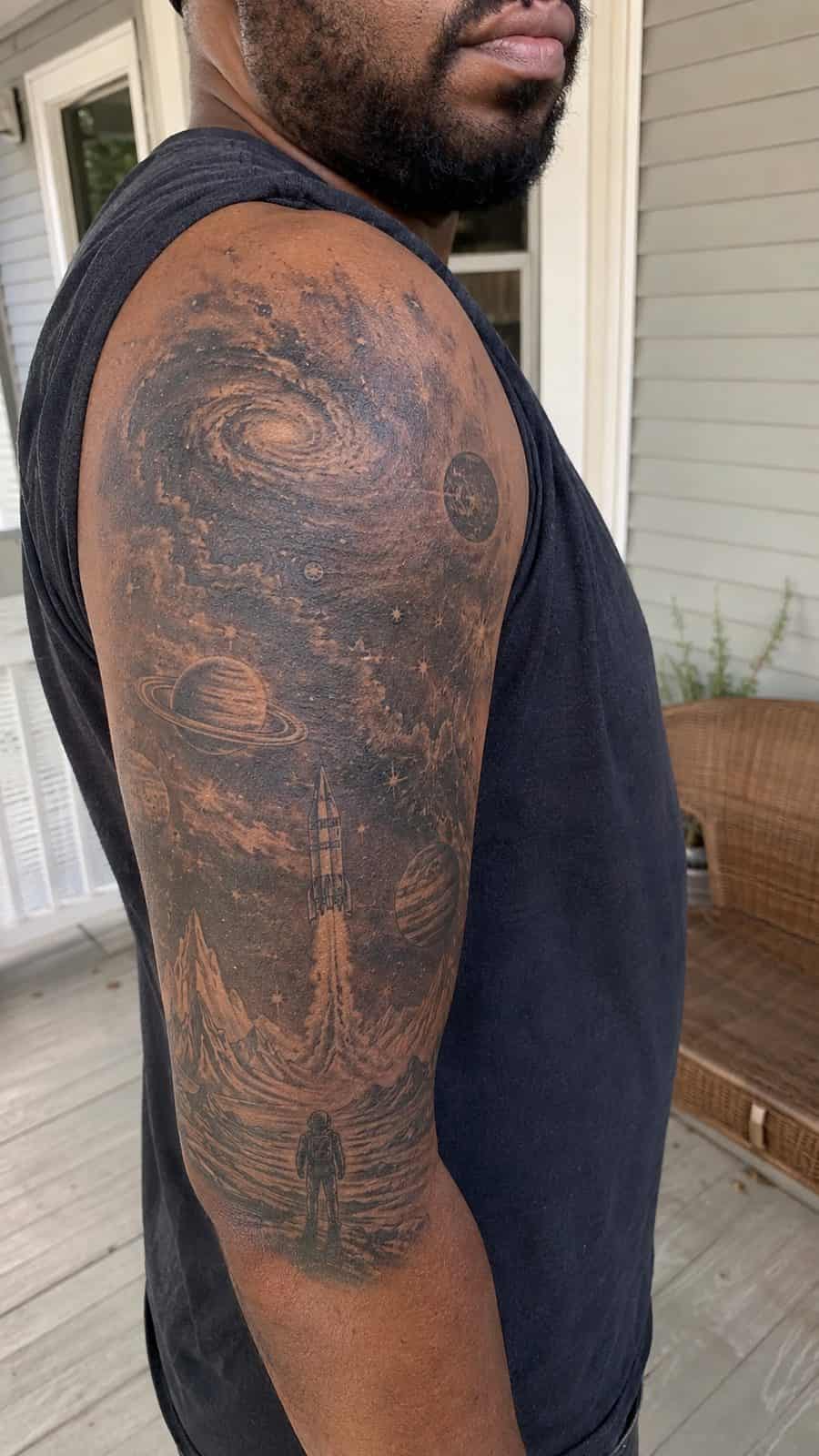 48 Tattoo Ideas for Men Worth Considering for Your Next Ink 22 Healed stellar odyssey tattoo on a adult man's outer upper arm, photographed in a natural casual close three-quarter view — study 1