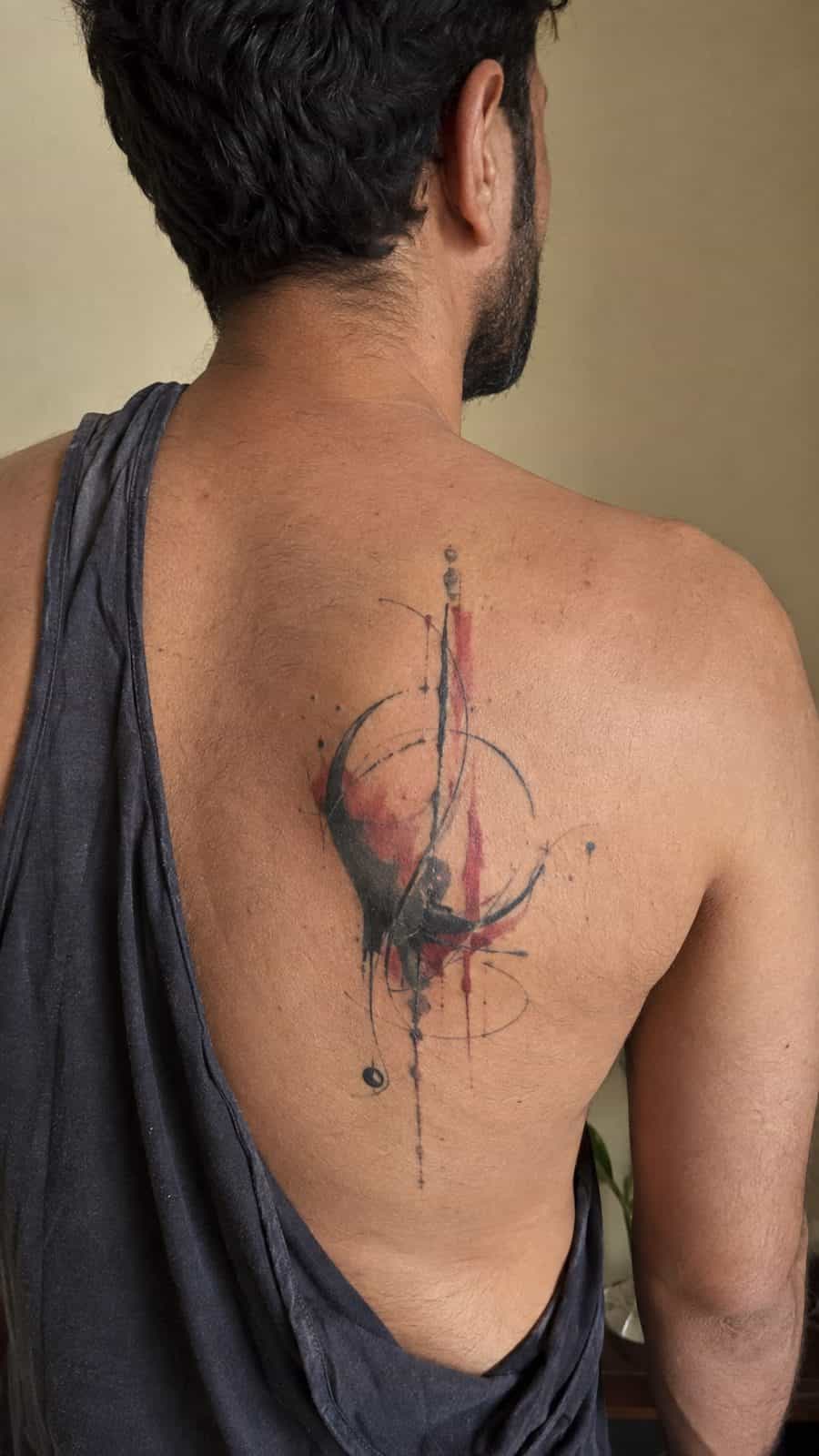 48 Tattoo Ideas for Men Worth Considering for Your Next Ink 31 Healed abstract expressions tattoo on a adult man's upper back, photographed in a natural relaxed documentary crop — study 2