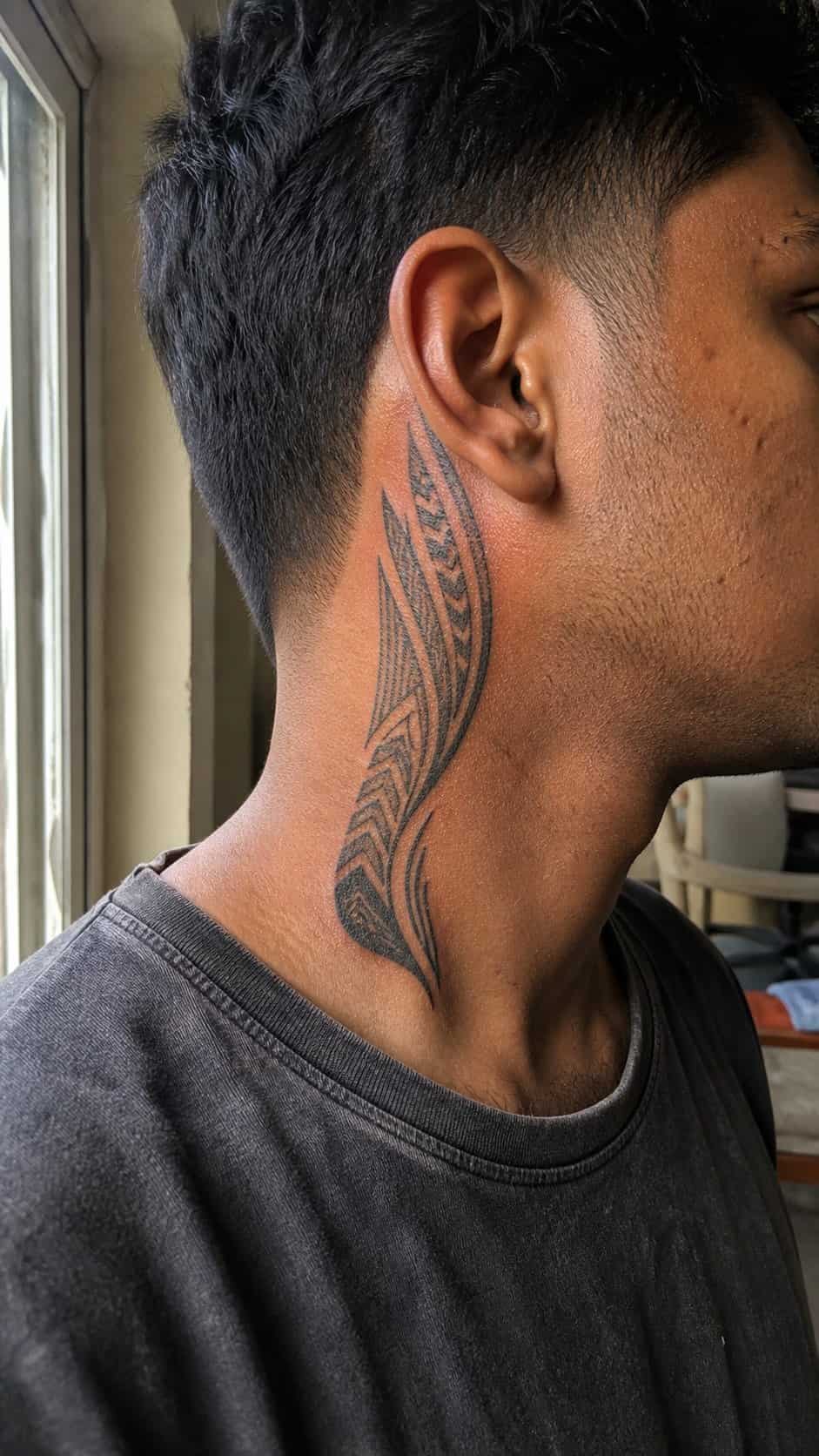 15 Neck Tattoo Ideas for Men Worth Considering 9 Healed tribal heritage tattoo on a adult man's side ribs, photographed in a natural straight-on close view, a touch off-center like a — study 1