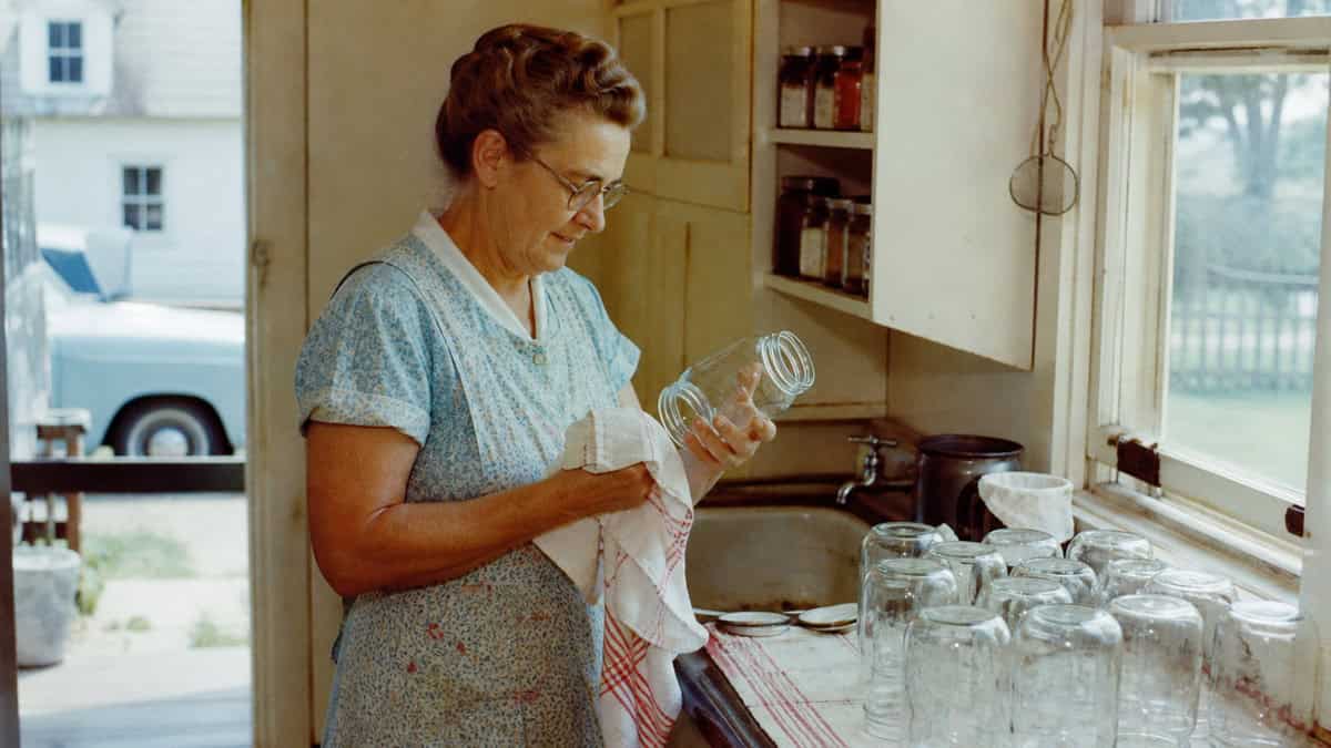 26 Things Grandma Never Threw Away (That Are Worth a Fortune Now) 6 Grandmother washing and saving mason jars in an early-1960s pantry