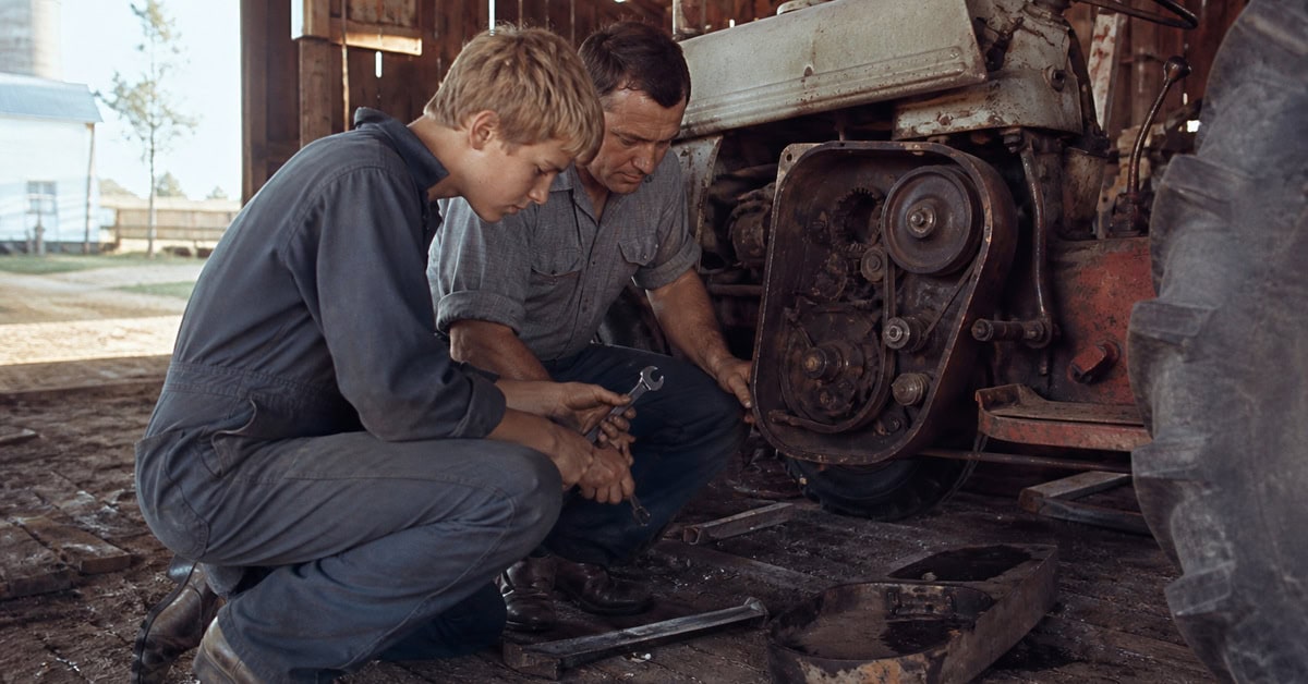 28 Things Every Farm Kid Could Do That City Kids Can't Imagine 12 Farm teenager repairing a tractor with a parent in the late 1960s