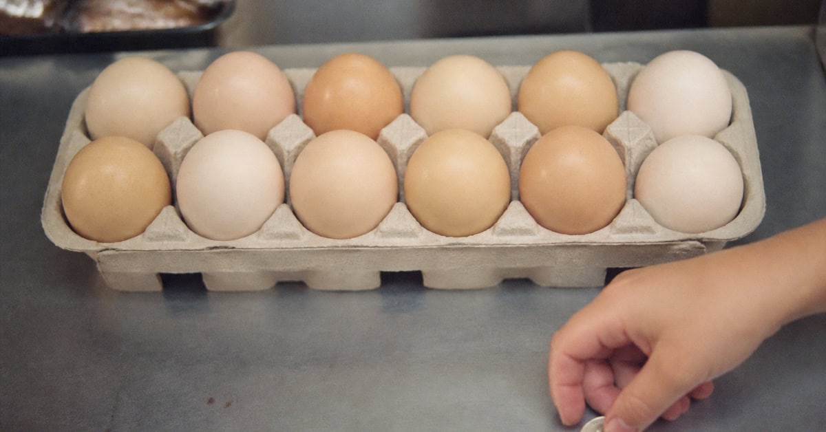Dozen eggs beside a child's quarter at a 1970 grocery counter