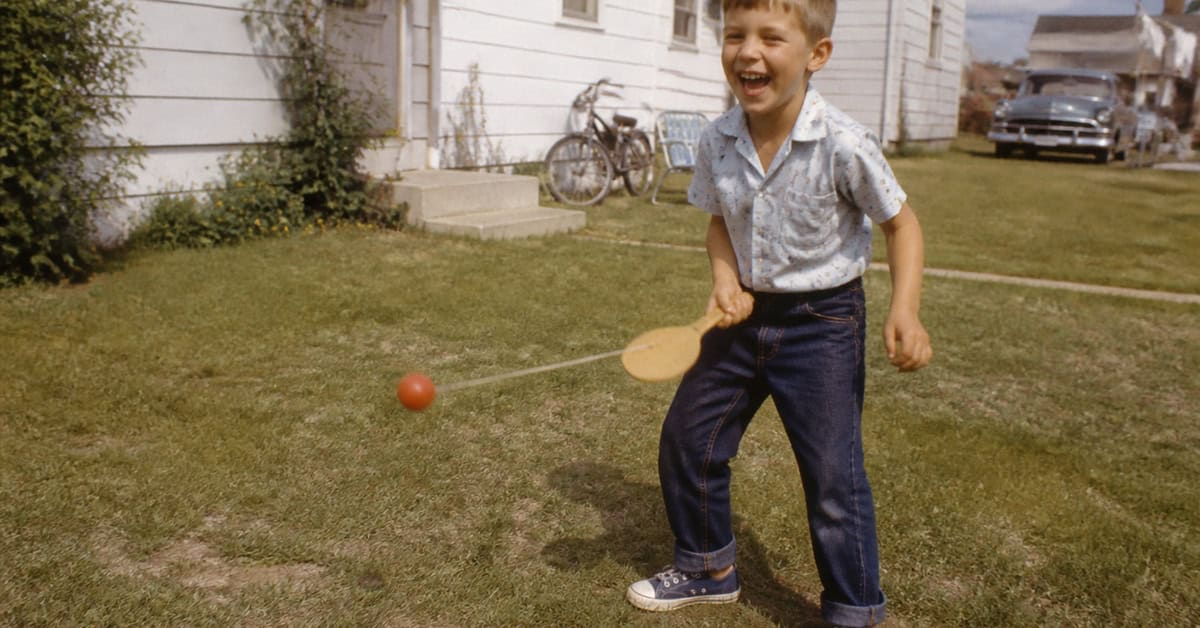 What You Could Actually Buy for Under a Dollar at the Toy Store 13 Child playing with a paddle ball in a 1960s backyard