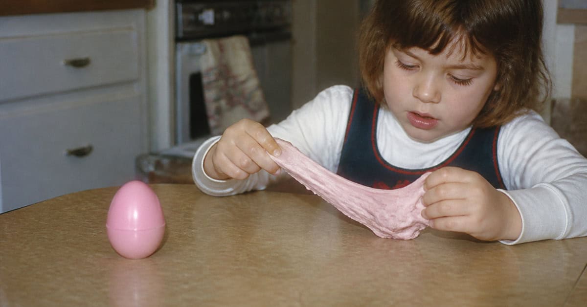 What You Could Actually Buy for Under a Dollar at the Toy Store 14 Child stretching pink putty at a kitchen table in the 1960s