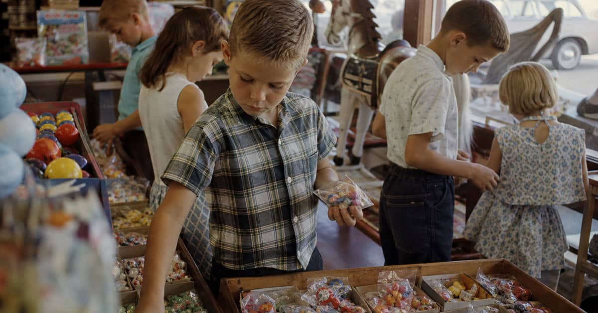 What You Could Actually Buy for Under a Dollar at the Toy Store 4 Child choosing a candy-and-toy treat at a 1960s toy store