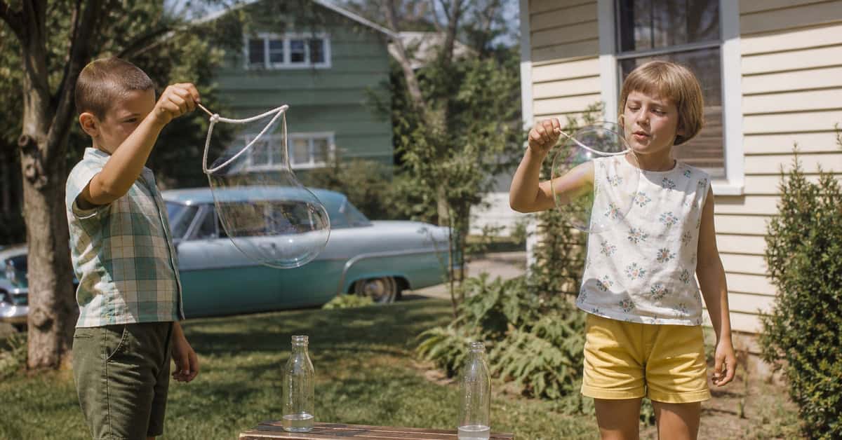What You Could Actually Buy for Under a Dollar at the Toy Store 7 Children blowing soap bubbles in a 1960s backyard
