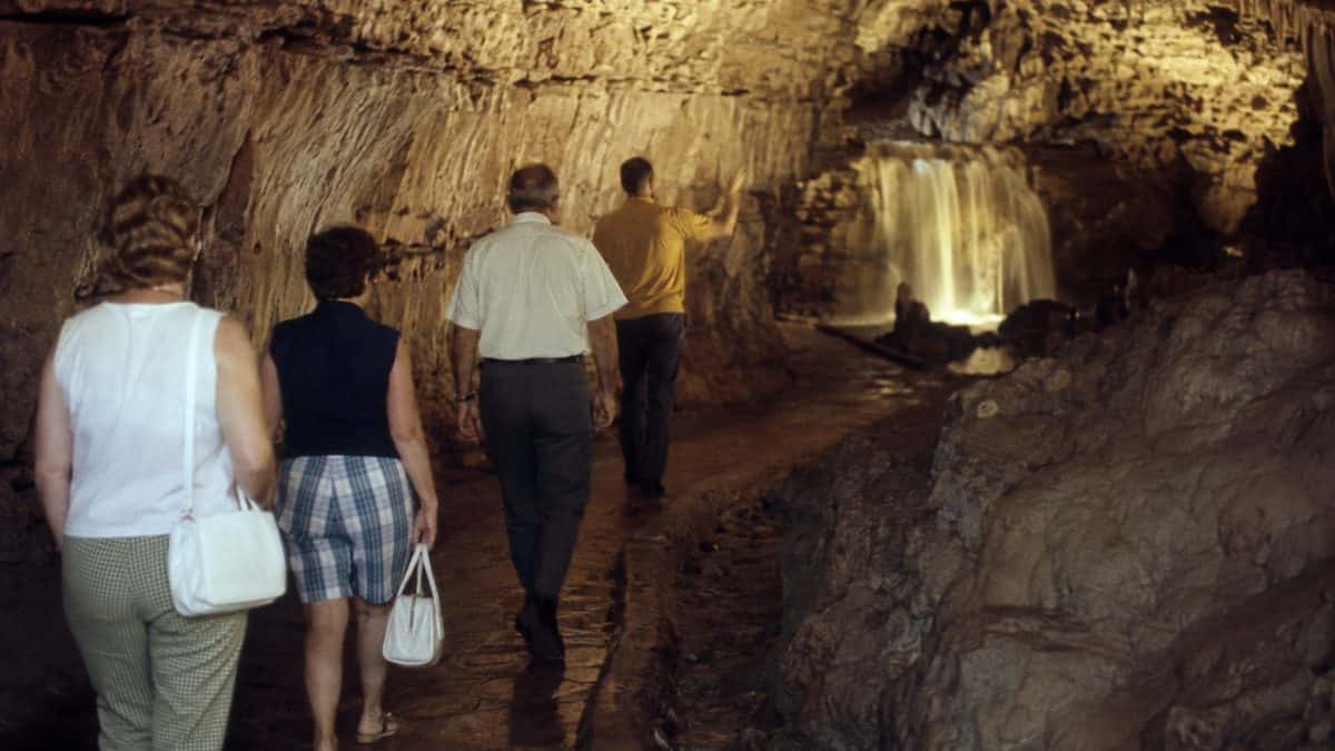 Tourists visiting an underground waterfall in Tennessee in the late 1960s