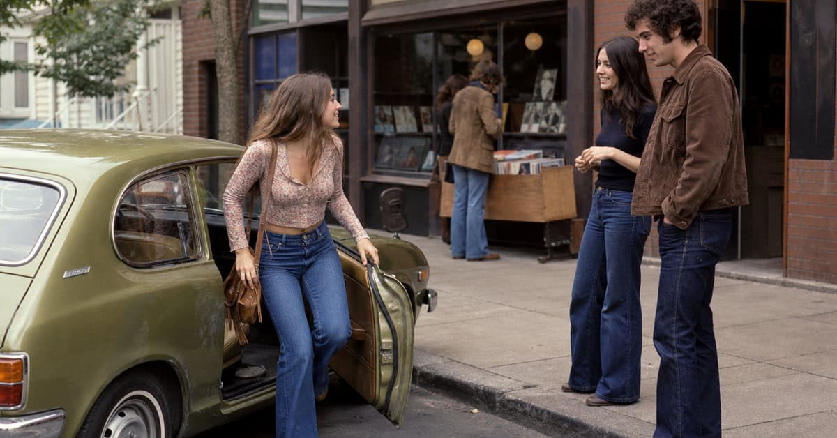 13 Classic Rock Ballads That Instantly Take You Back 3 Young woman meeting friends outside a record shop in 1970