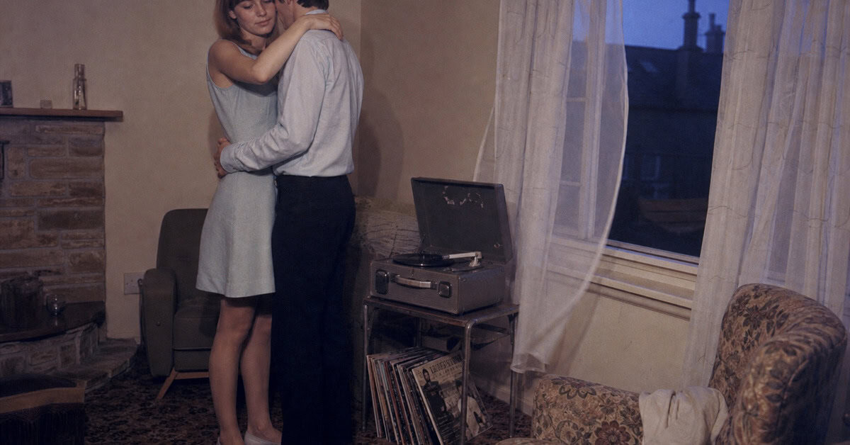 13 Classic Rock Ballads That Instantly Take You Back 7 Young couple slow-dancing beside a record player in the late 1960s