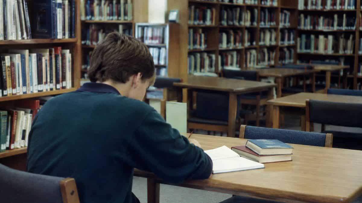 You Won't Always Have a Calculator!' (And 9 Other School Lies We Believed) 9 Student in a 1990s library writing on notebook paper