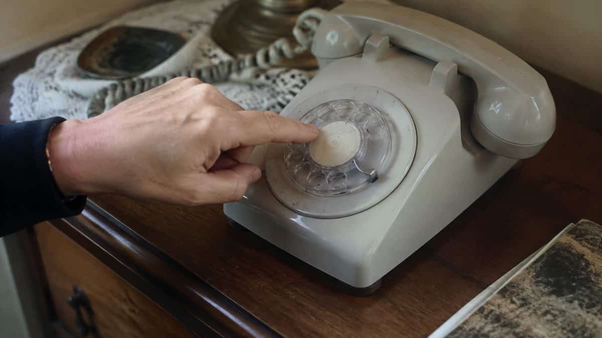 14 Things Every Kid Who Used a Rotary Phone Remembers 7 Authentic black and white photo of hand holding vintage handset